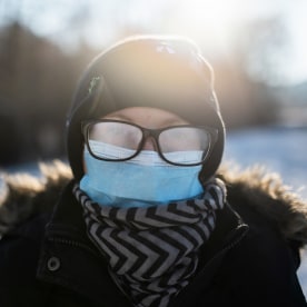 Woman Winter walk with face mask and fogged up eyeglasses.